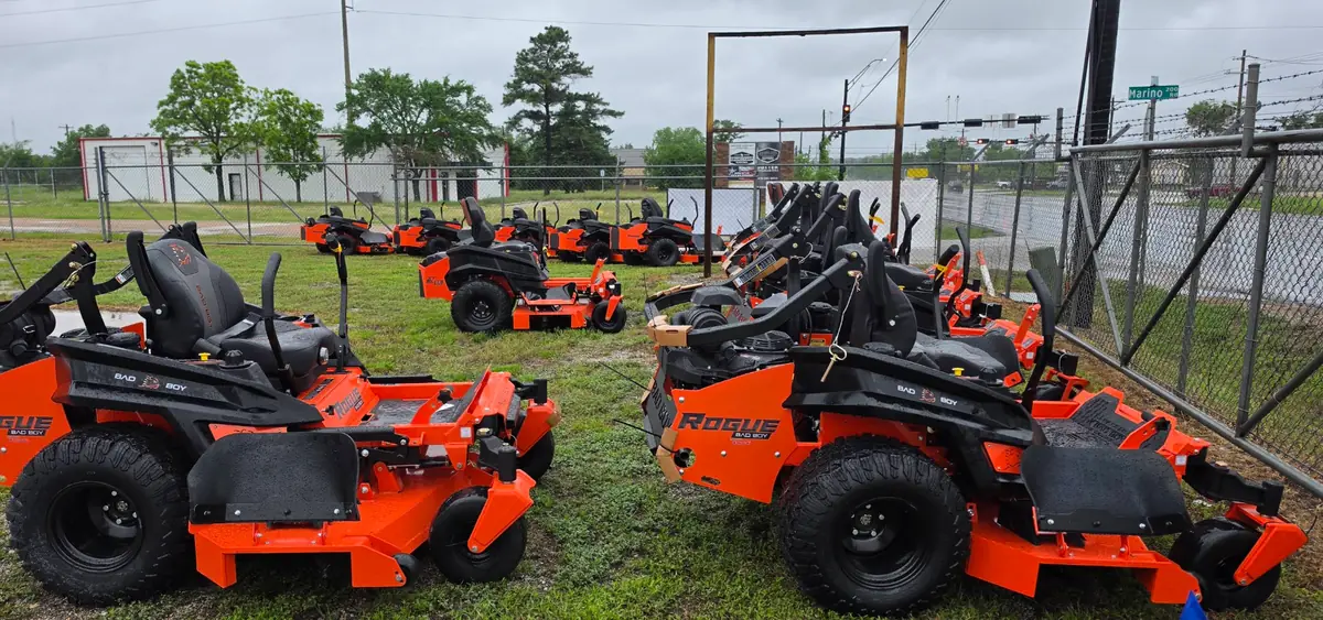 Bad Boy Rogue zero-turn mowers lined up on the lot at J5 Tractors in Bryan, Texas