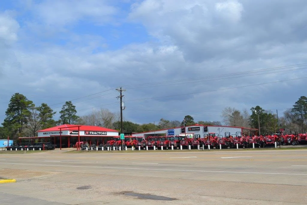 The J5 Tractors store in Buna, Texas, seen from U.S. 96, with Mahindra tractors along the front