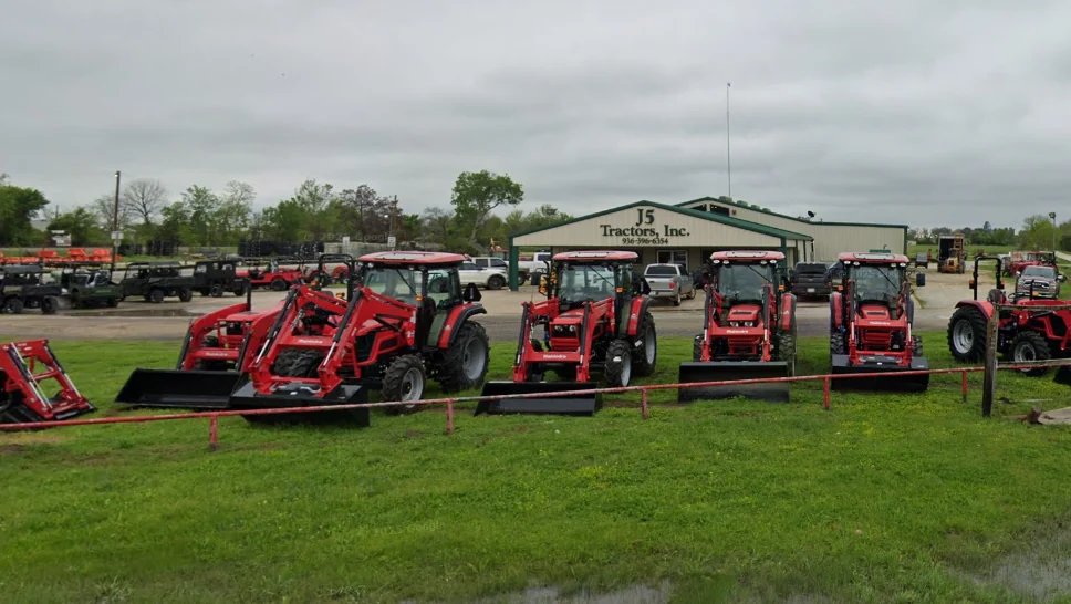 Mahindra cab tractors with front loaders in front of the J5 Tractors building in Normangee, Texas